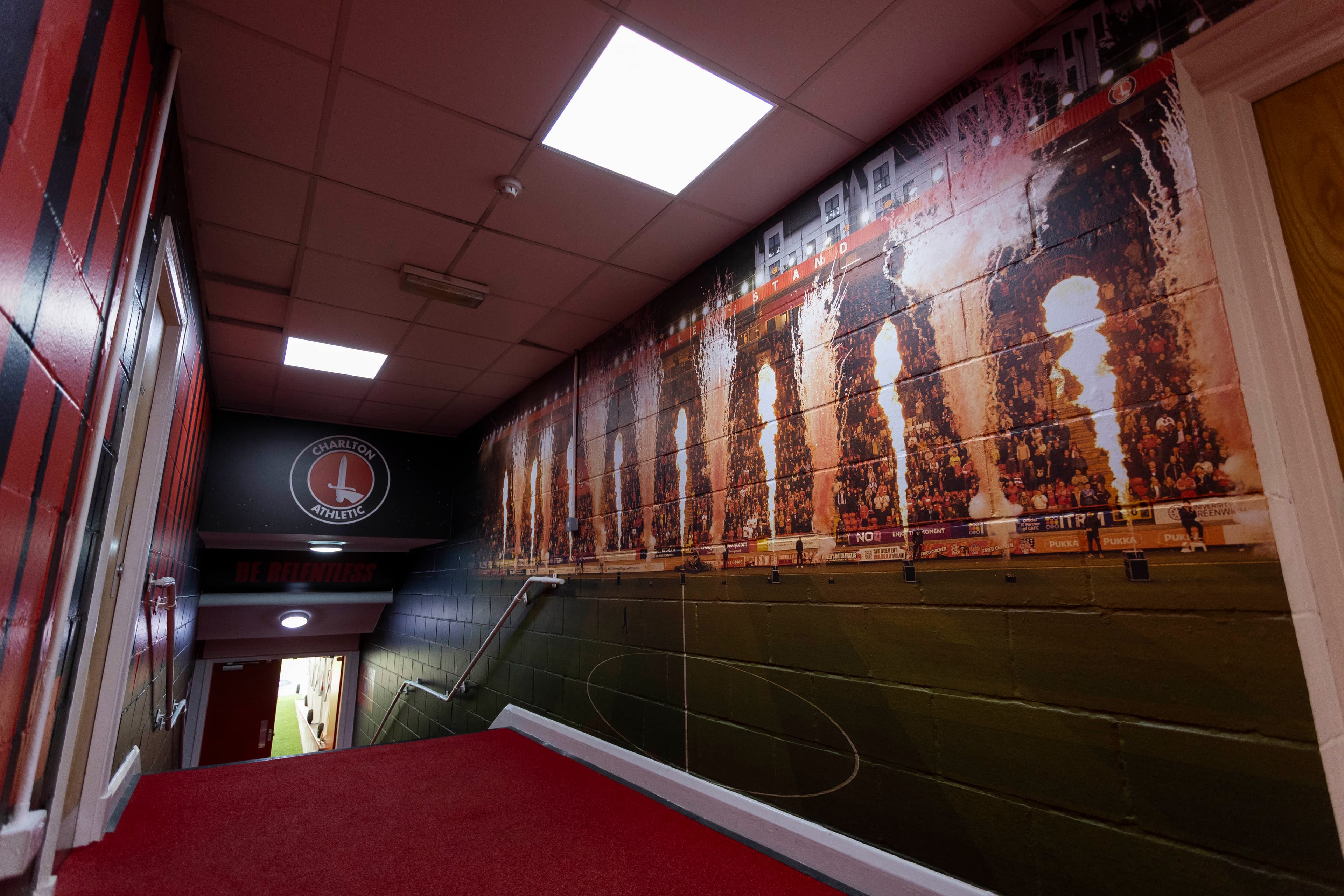 Staircase graphics leading toward the pitch at The Valley